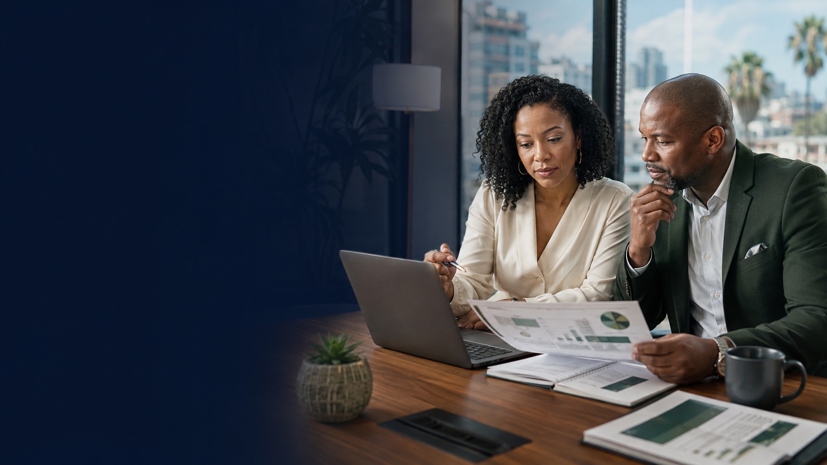 Los Angeles business owner reviewing financial reports with an accounting and controller-services professional