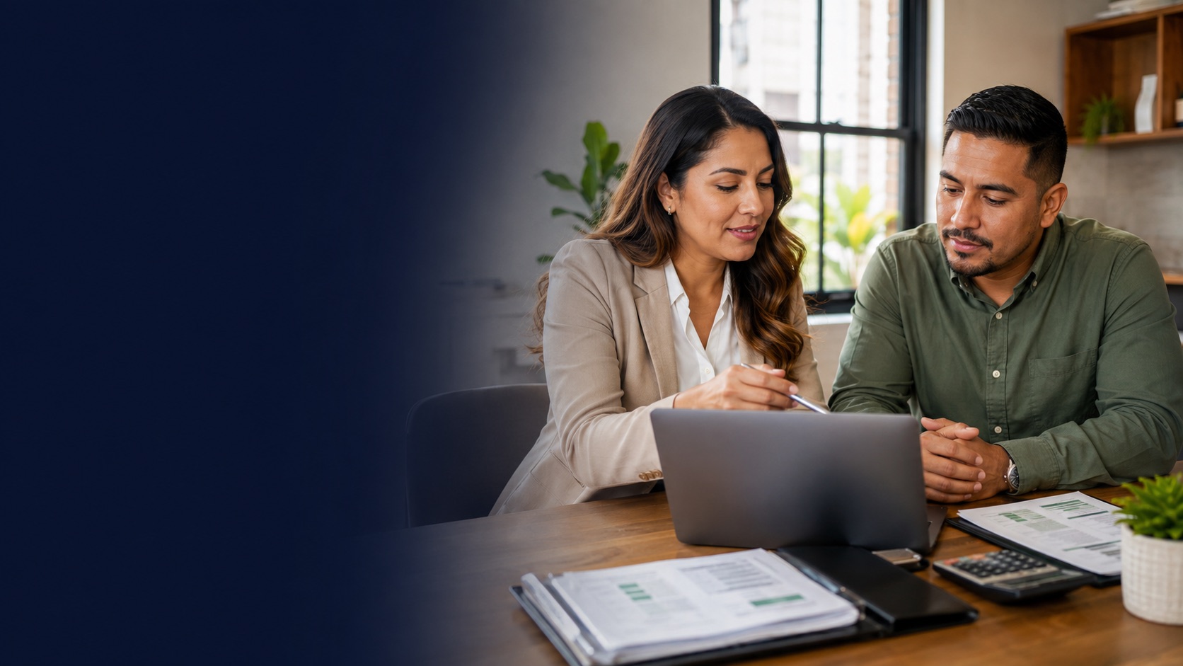 Small-business owner reviewing payroll records with an experienced payroll support professional